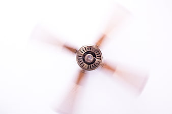 Spinning Ceiling Fan With Motion Blur Against White Background