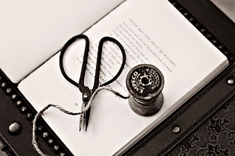 Vintage Scissors and Thread Spool on Open Book