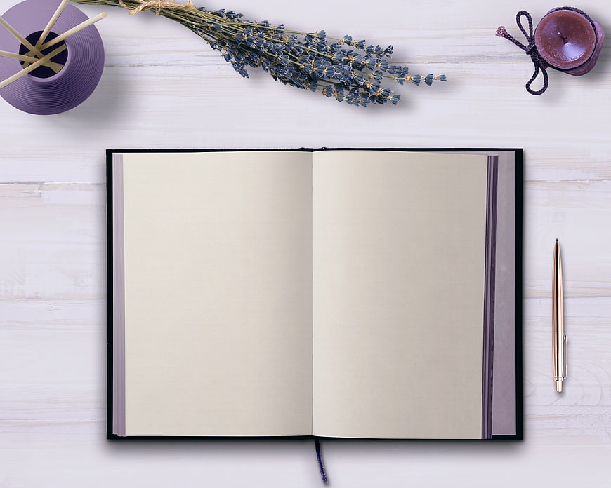 Open blank notebook with lavender and purple accessories flat lay