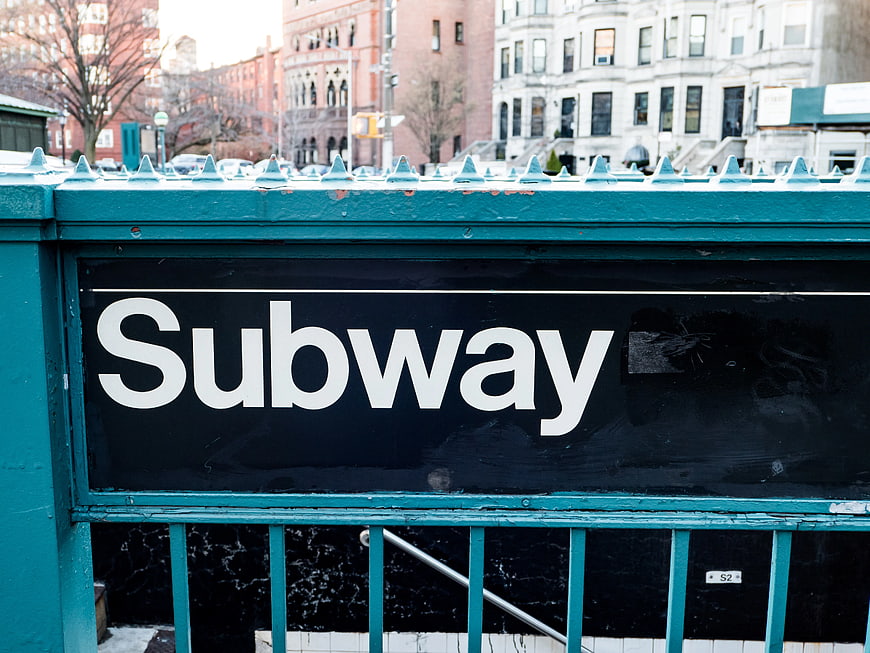 New York City Subway Entrance Sign on Teal Gate
