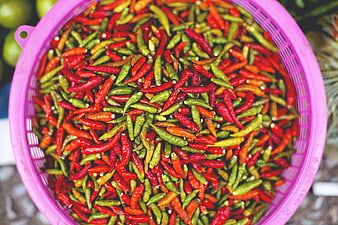 Top View of Fresh Red and Green Chilies in Pink Basket
