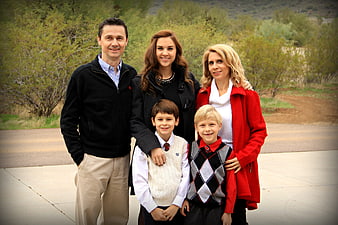 Happy family portrait outdoors with children in school uniforms