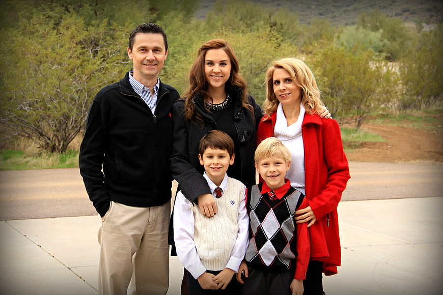 Happy family portrait outdoors with children in school uniforms
