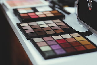 Professional makeup artist eyeshadow palettes on white table