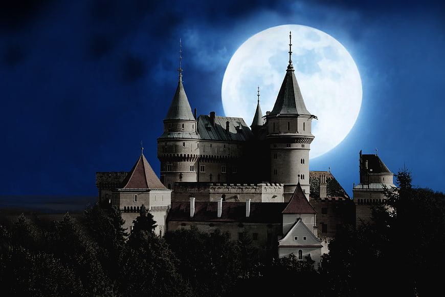 Mystical Castle Silhouette Against Giant Full Moon