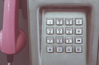 Close-up of vintage pink telephone keypad