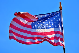 American Flag Waving Against Clear Blue Sky