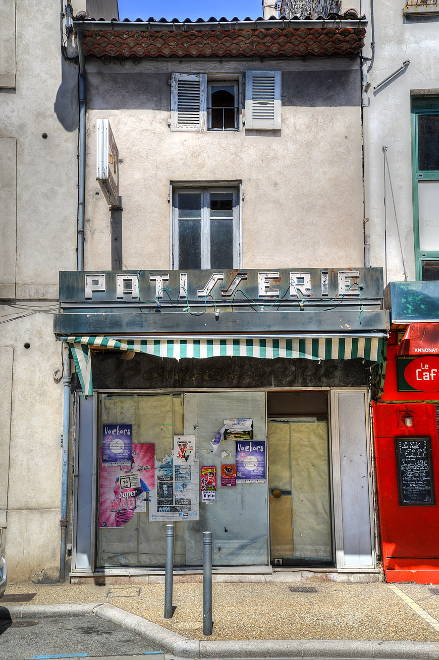 Closed French Patiserie Shop Front with Striped Awning