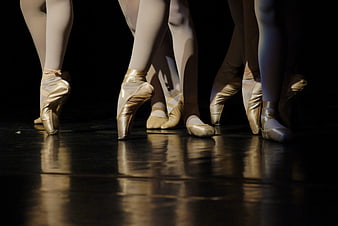 Ballet Dancers' Feet in Pointe Shoes on Stage