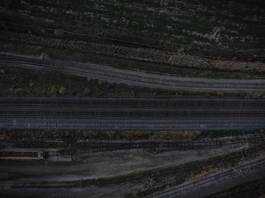 Aerial view of multiple railway tracks through green landscape
