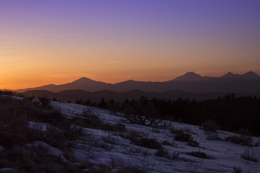 Snowy Mountain Landscape at Sunset with Purple Sky