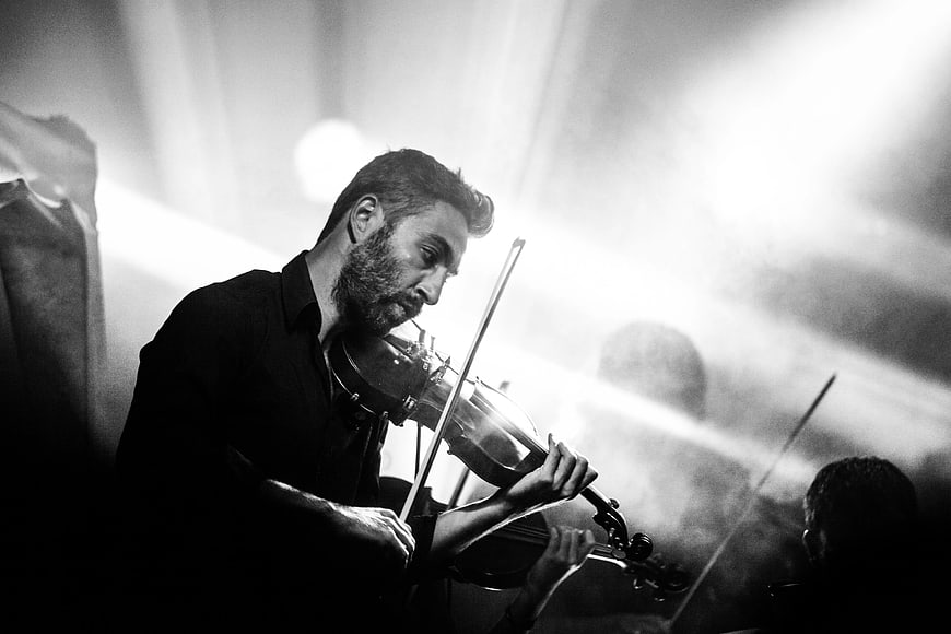 Dramatic Black and White Violinist Performing on Stage