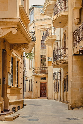 Narrow historic stone street in Baku, Azerbaijan with balconies