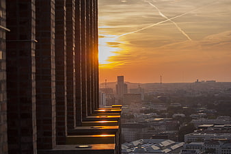 Golden Sunset View Over City Skyline from High-Rise Balcony