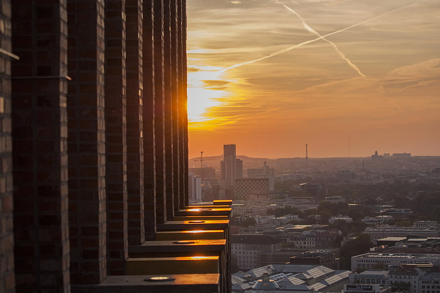 Golden Sunset View Over City Skyline from High-Rise Balcony