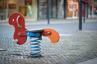 Lonely red spring rider on cobblestone street