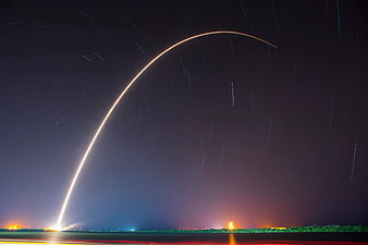 Long Exposure Rocket Launch with Star Trails at Night