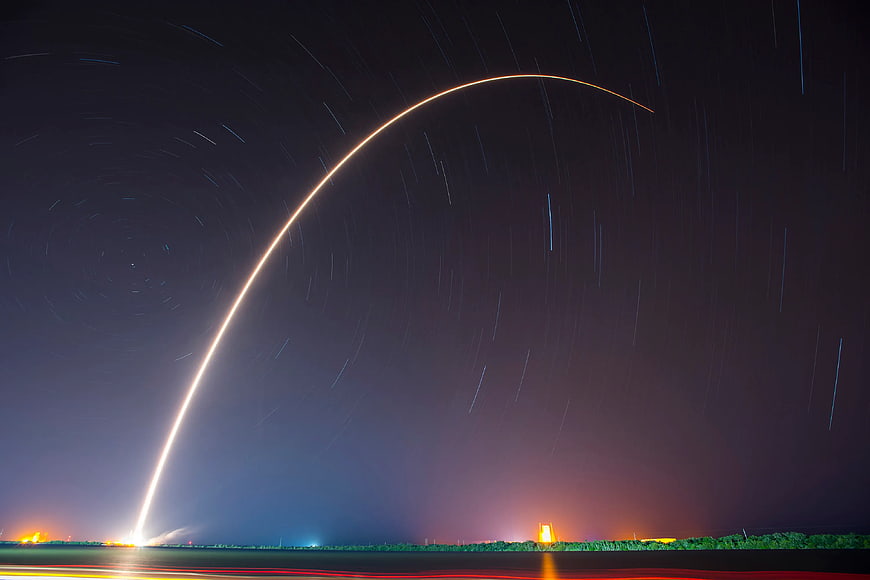 Long Exposure Rocket Launch with Star Trails at Night