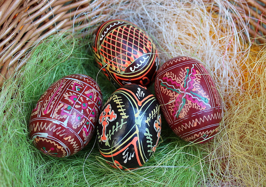 Traditional Easter Eggs in Wicker Basket with Moss
