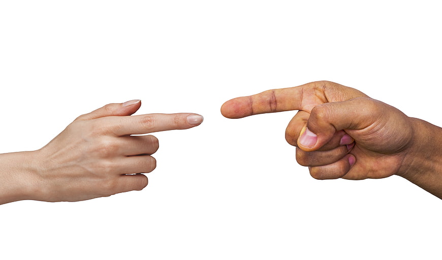 Two hands pointing at each other on white background