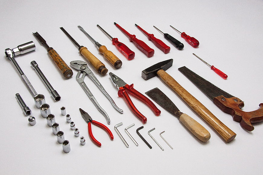 Assorted Hand Tools and Hardware on White Background
