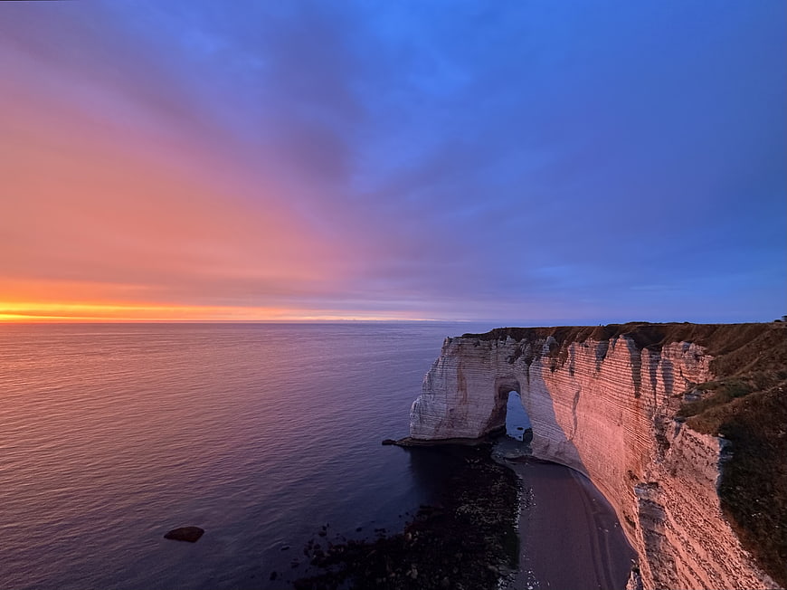 Dramatic Sunset Over White Cliffs and Ocean Arch
