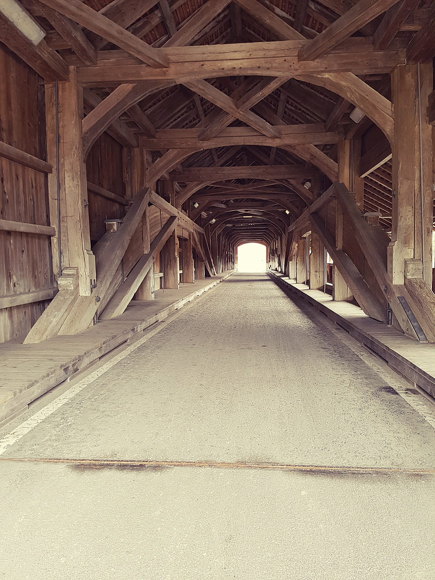 Interior view of historic wooden covered bridge with leading lines