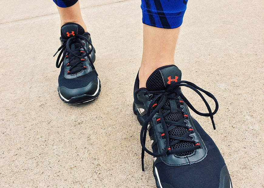 Close-up of black running shoes on concrete pavement