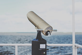 Gold Coin-Operated Telescope on Ferry Deck Overlooking Sea