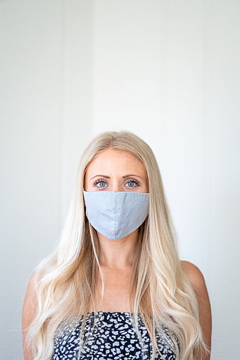 Portrait of Blonde Woman Wearing Blue Face Mask