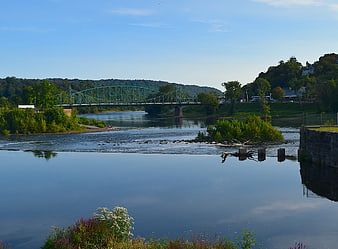 Green Truss Bridge Over River With Reflections