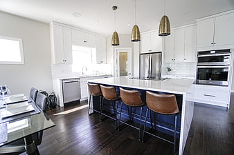 Modern White Kitchen With Marble Island And Leather Bar Stools