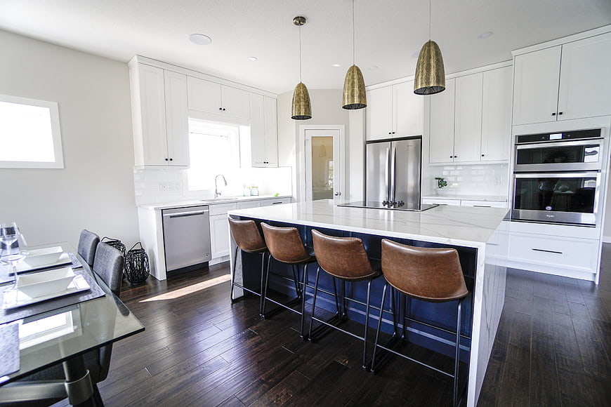 Modern White Kitchen With Marble Island And Leather Bar Stools