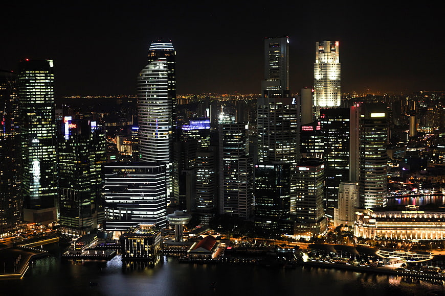 Singapore skyline at night with illuminated skyscrapers and waterfront