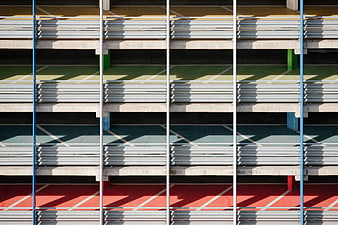 Colorful parking garage facade with metal slats and shadows