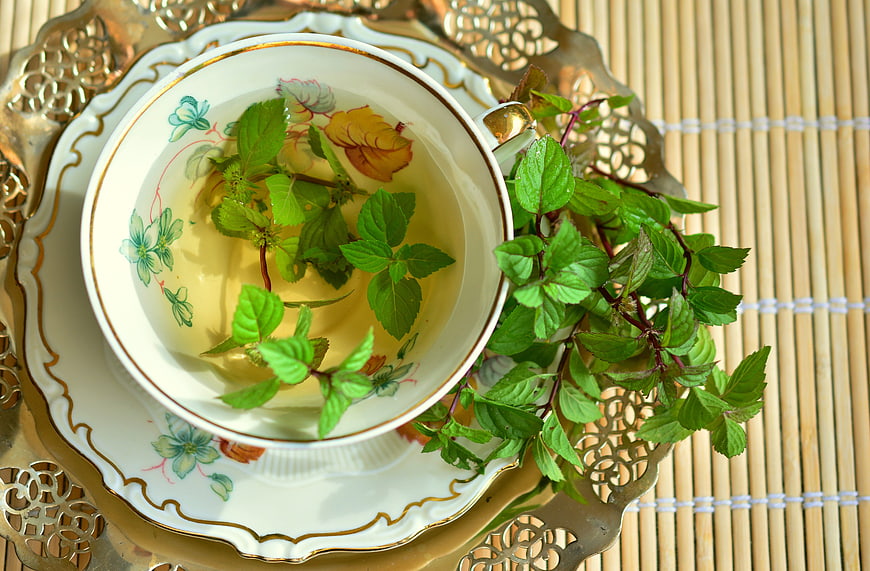 Fresh Mint Tea in Vintage Cup on Bamboo Mat