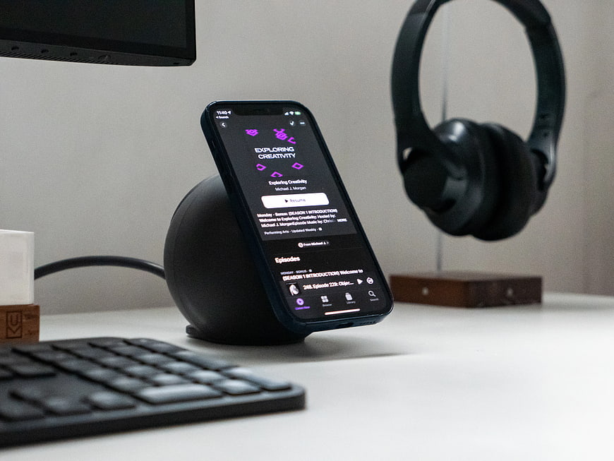 Smartphone on Desk with Podcast App and Headphones