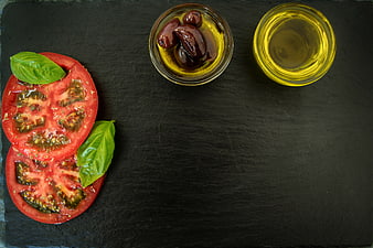 Fresh Tomato Slices, Basil, and Olive Oil on Slate
