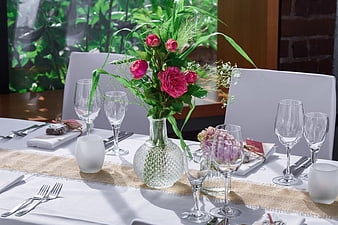 Elegant table setting with pink roses and glassware