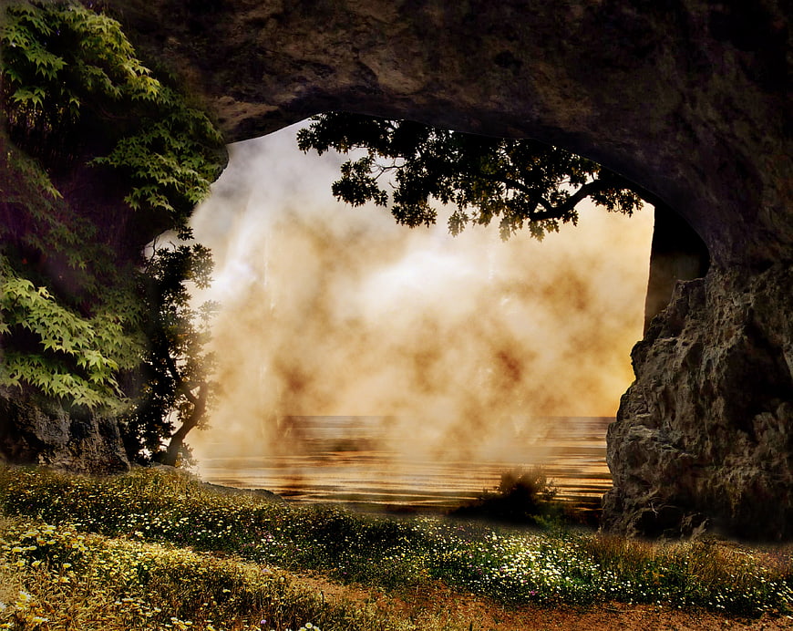 Mystical Cave Opening Framing Misty Lake and Wildflowers