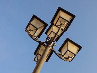 Low angle view of vintage street lamp against blue sky