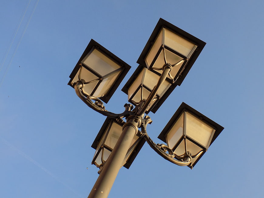 Low angle view of vintage street lamp against blue sky