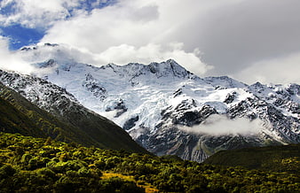 Majestic Snow-Capped Mountain Peak with Glaciers and Forest