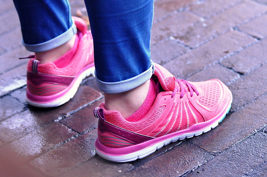Pink Running Shoes On Wet Brick Pavement