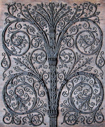 Ornate Cast Iron Tree Pattern on Wooden Background