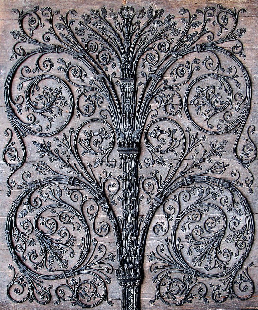 Ornate Cast Iron Tree Pattern on Wooden Background
