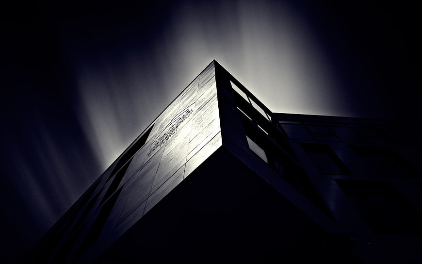 Dramatic low angle view of modern building corner at night