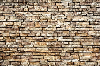 Textured beige stone wall background pattern