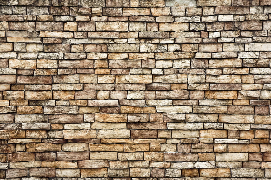 Textured beige stone wall background pattern