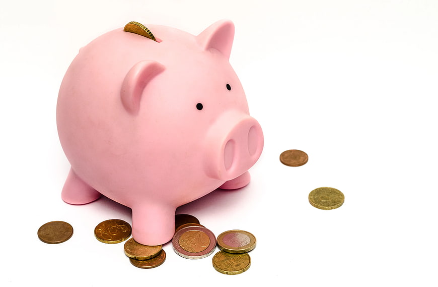 Pink Piggy Bank with Euro Coins on White Background